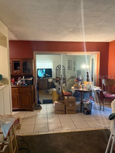 4339 Solomon Dr, Orlando, FL 32811 - living room with light tile patterned floors and a textured ceiling
