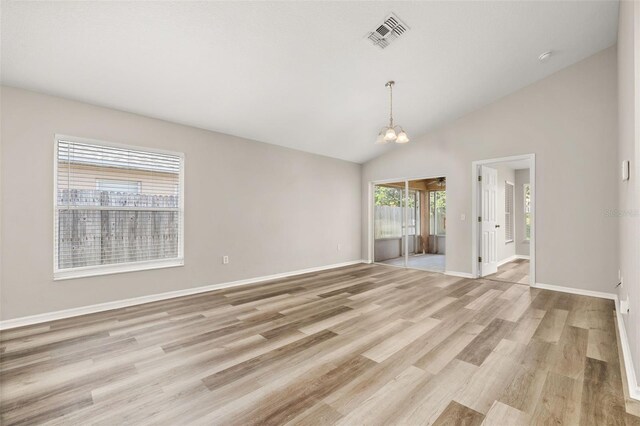 2146 Fish Eagle St, Clermont, FL 34714 - unfurnished room with light wood-style flooring, a chandelier, baseboards, and lofted ceiling