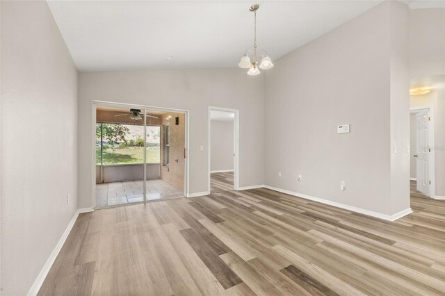 2146 Fish Eagle St, Clermont, FL 34714 - unfurnished room featuring light wood-style flooring, a chandelier, baseboards, and high vaulted ceiling
