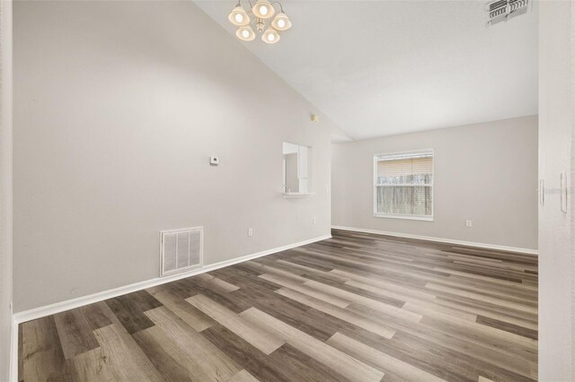 2146 Fish Eagle St, Clermont, FL 34714 - spare room featuring high vaulted ceiling, wood finished floors, and baseboards