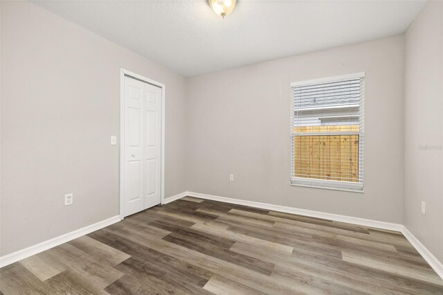 2146 Fish Eagle St, Clermont, FL 34714 - spare room with baseboards and wood finished floors