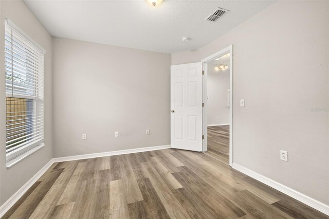 2146 Fish Eagle St, Clermont, FL 34714 - unfurnished room featuring wood finished floors, baseboards, and a smoke detector