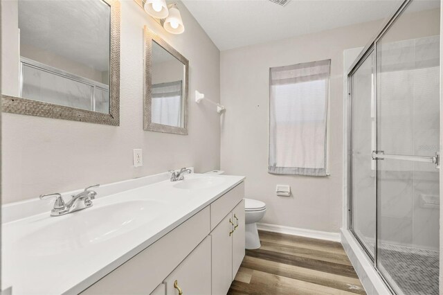 2146 Fish Eagle St, Clermont, FL 34714 - bathroom with toilet, double vanity, baseboards, and a shower stall