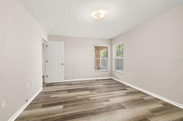 2146 Fish Eagle St, Clermont, FL 34714 - spare room with baseboards, wood finished floors, and a textured ceiling