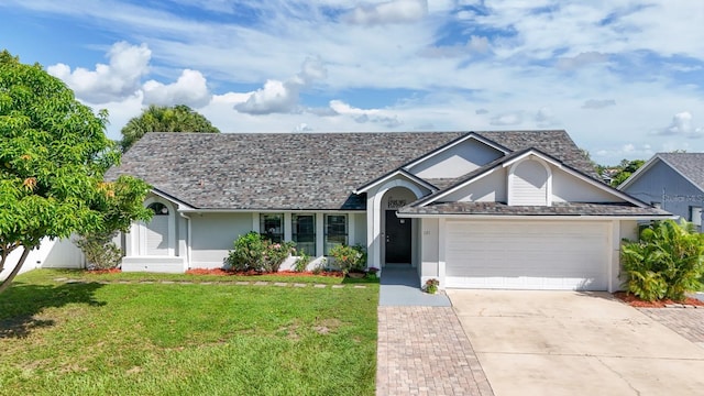 121 White Birch Dr, Kissimmee, FL 34743 - view of front of house featuring an attached garage, concrete driveway, a front yard, and stucco siding
