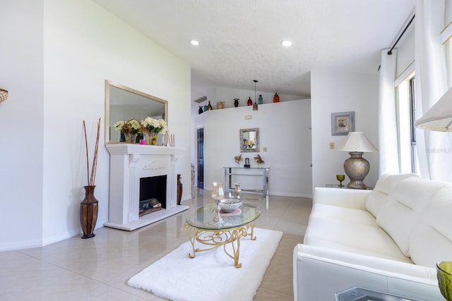 121 White Birch Dr, Kissimmee, FL 34743 - living room featuring lofted ceiling, recessed lighting, light tile patterned floors, and a fireplace with raised hearth