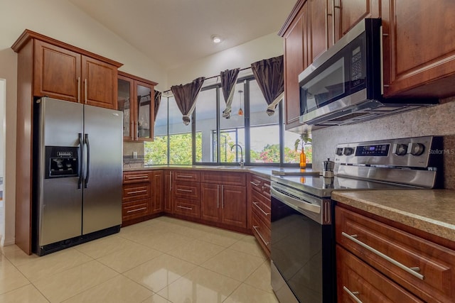 121 White Birch Dr, Kissimmee, FL 34743 - kitchen featuring stainless steel appliances, backsplash, glass insert cabinets, light tile patterned floors, and dark countertops
