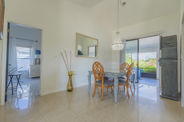 121 White Birch Dr, Kissimmee, FL 34743 - dining area with a chandelier, plenty of natural light, light tile patterned flooring, and a high ceiling