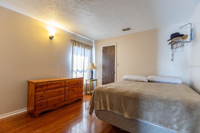 121 White Birch Dr, Kissimmee, FL 34743 - bedroom featuring wood-type flooring and a textured ceiling