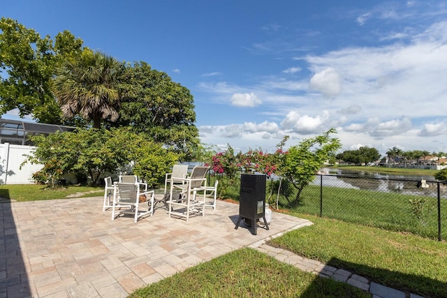 121 White Birch Dr, Kissimmee, FL 34743 - fenced backyard featuring outdoor dining space, a patio area, and a water view