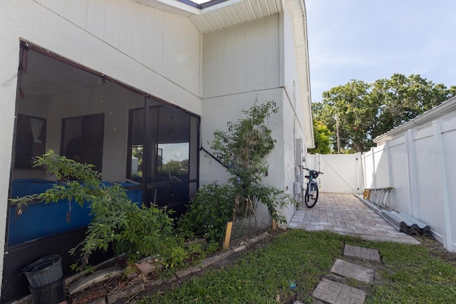 121 White Birch Dr, Kissimmee, FL 34743 - view of side of home featuring a gate