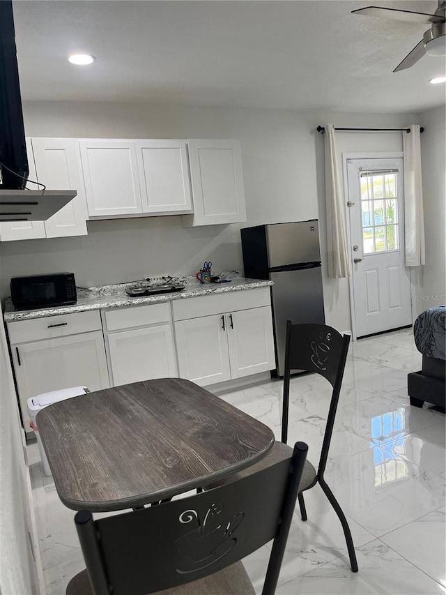 121 White Birch Dr, Kissimmee, FL 34743 - kitchen featuring freestanding refrigerator, light marble finish floors, white cabinets, ceiling fan, and recessed lighting