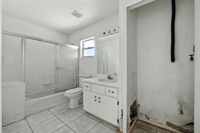 3252 Golfview Rd, Sebring, FL 33875 - full bathroom featuring vanity, combined bath / shower with glass door, tile patterned flooring, and a textured ceiling