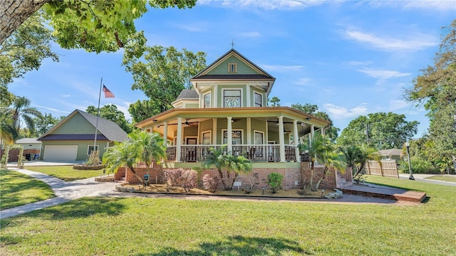 822 W Patterson St, Lakeland, FL 33803 - victorian home with covered porch, a front lawn, ceiling fan, a garage, and driveway