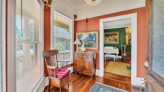 822 W Patterson St, Lakeland, FL 33803 - living area with wood finished floors, crown molding, a chandelier, and baseboards