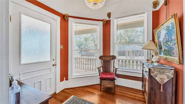 822 W Patterson St, Lakeland, FL 33803 - living area with wood finished floors, a chandelier, and baseboards