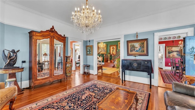 822 W Patterson St, Lakeland, FL 33803 - living area featuring a chandelier, wood finished floors, ornamental molding, and baseboards