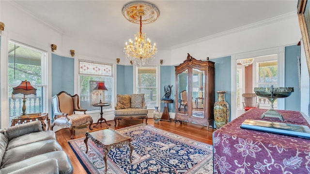 822 W Patterson St, Lakeland, FL 33803 - living area with a chandelier, wood finished floors, ornamental molding, and plenty of natural light