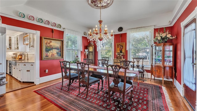 822 W Patterson St, Lakeland, FL 33803 - dining room with a chandelier, healthy amount of natural light, and light wood-type flooring
