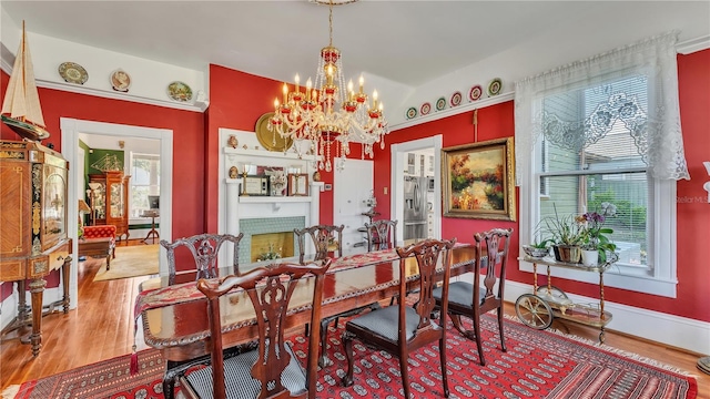 822 W Patterson St, Lakeland, FL 33803 - dining room featuring a chandelier, wood finished floors, and baseboards