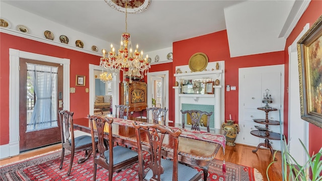 822 W Patterson St, Lakeland, FL 33803 - dining area with a chandelier, wood finished floors, and baseboards