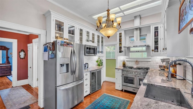 822 W Patterson St, Lakeland, FL 33803 - kitchen with appliances with stainless steel finishes, wine cooler, a sink, a chandelier, and white cabinetry