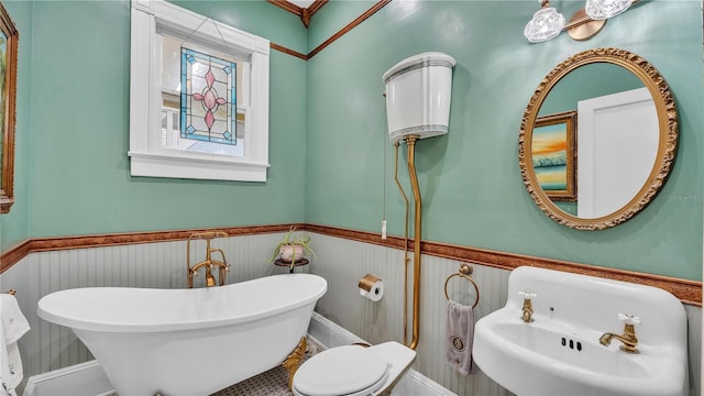 822 W Patterson St, Lakeland, FL 33803 - full bathroom featuring wainscoting, a soaking tub, a sink, and toilet