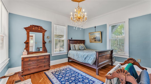 822 W Patterson St, Lakeland, FL 33803 - bedroom with a chandelier, ornamental molding, light wood-type flooring, and baseboards