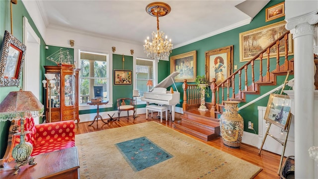 822 W Patterson St, Lakeland, FL 33803 - sitting room featuring stairway, a chandelier, wood finished floors, crown molding, and baseboards