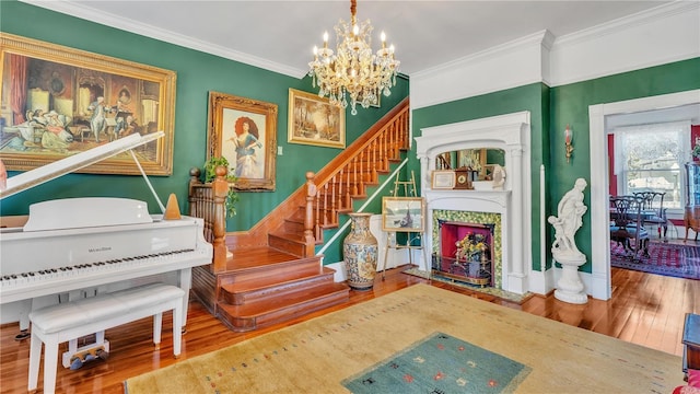 822 W Patterson St, Lakeland, FL 33803 - stairs with wood finished floors, a chandelier, ornamental molding, and a fireplace with flush hearth