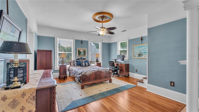 822 W Patterson St, Lakeland, FL 33803 - bedroom with ornate columns, baseboards, wood finished floors, an office area, and a ceiling fan