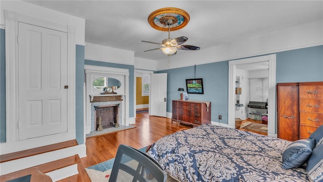 822 W Patterson St, Lakeland, FL 33803 - bedroom with wood finished floors, a premium fireplace, baseboards, and a ceiling fan