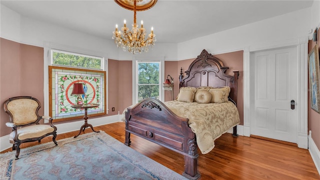 822 W Patterson St, Lakeland, FL 33803 - bedroom with wood finished floors, a chandelier, and baseboards