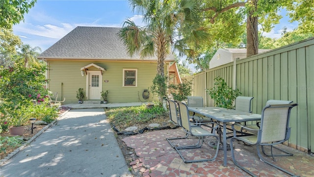 822 W Patterson St, Lakeland, FL 33803 - view of front of house featuring outdoor dining space, a patio, and roof with shingles
