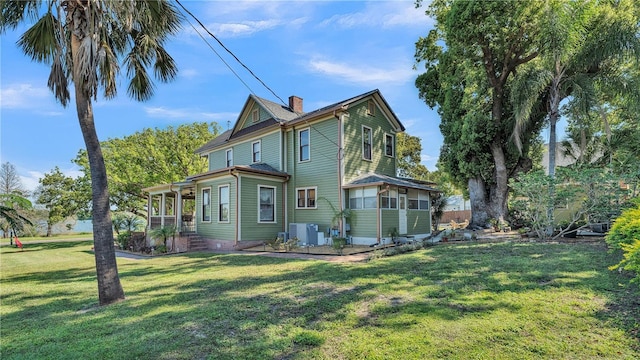 822 W Patterson St, Lakeland, FL 33803 - back of house featuring a chimney and a lawn