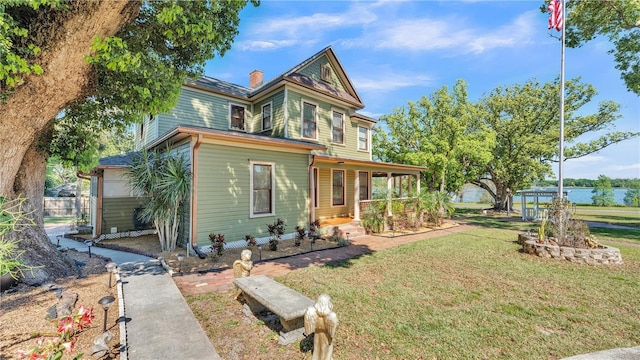 822 W Patterson St, Lakeland, FL 33803 - view of front of property with a chimney and a water view