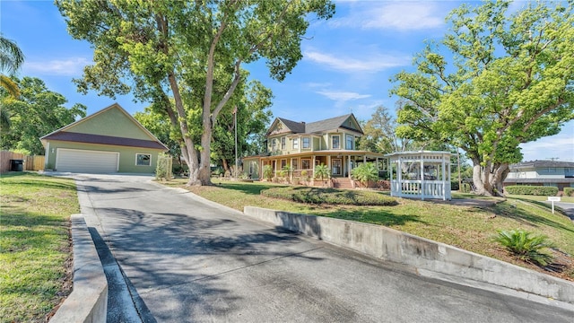 822 W Patterson St, Lakeland, FL 33803 - victorian house featuring a front lawn, driveway, and a garage