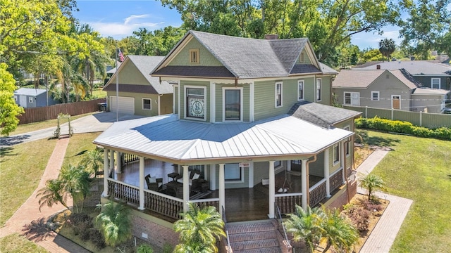 822 W Patterson St, Lakeland, FL 33803 - back of house featuring a porch, a chimney, a garage, concrete driveway, and roof with shingles