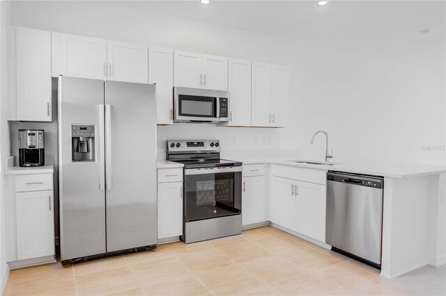 8540 Daybreak St, Sarasota, FL 34241 - kitchen with appliances with stainless steel finishes, a sink, white cabinetry, light countertops, and recessed lighting