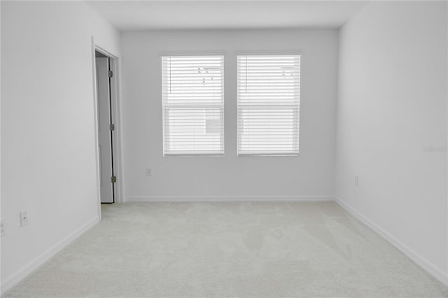 8540 Daybreak St, Sarasota, FL 34241 - empty room with light colored carpet, healthy amount of natural light, and baseboards
