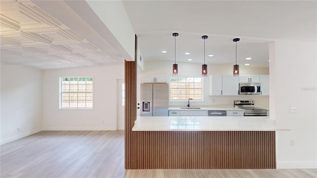3621 Devonswood Dr, Orlando, FL 32806 - kitchen featuring stainless steel appliances, light wood finished floors, healthy amount of natural light, a sink, and recessed lighting