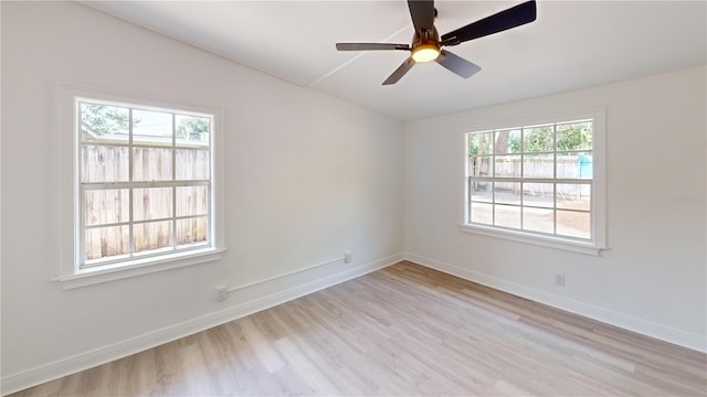 3621 Devonswood Dr, Orlando, FL 32806 - empty room featuring vaulted ceiling, light wood-style floors, plenty of natural light, baseboards, and ceiling fan