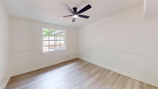 3621 Devonswood Dr, Orlando, FL 32806 - spare room with light wood-style flooring, wainscoting, and a ceiling fan