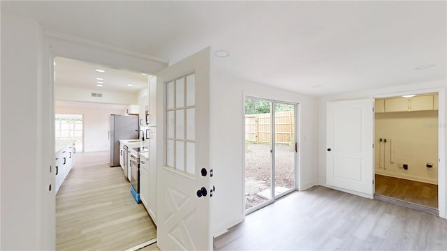 3621 Devonswood Dr, Orlando, FL 32806 - entryway with light wood finished floors, a sink, and baseboards