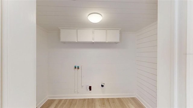 3621 Devonswood Dr, Orlando, FL 32806 - laundry room with cabinet space, light wood-style flooring, hookup for a washing machine, and ornamental molding