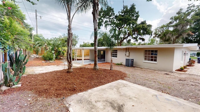 3621 Devonswood Dr, Orlando, FL 32806 - view of front of property with stucco siding, a patio area, a fenced backyard, and central air condition unit