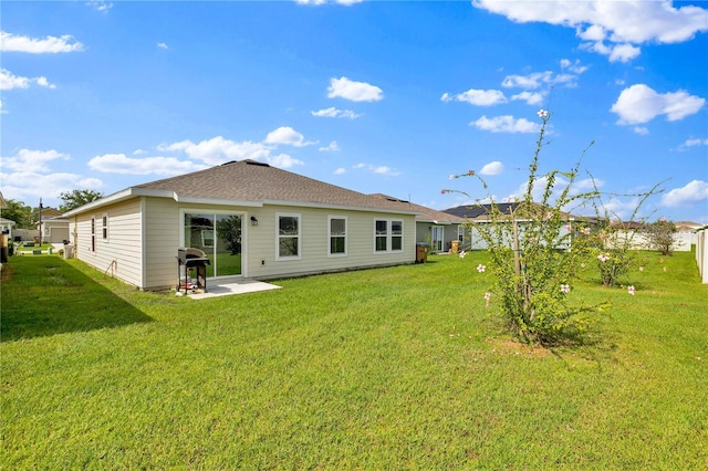 4492 Bluff Oak Loop, Kissimmee, FL 34746 - back of house with a patio area and a lawn