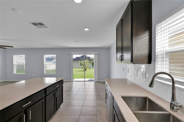 4492 Bluff Oak Loop, Kissimmee, FL 34746 - kitchen featuring a sink, open floor plan, light countertops, backsplash, and recessed lighting