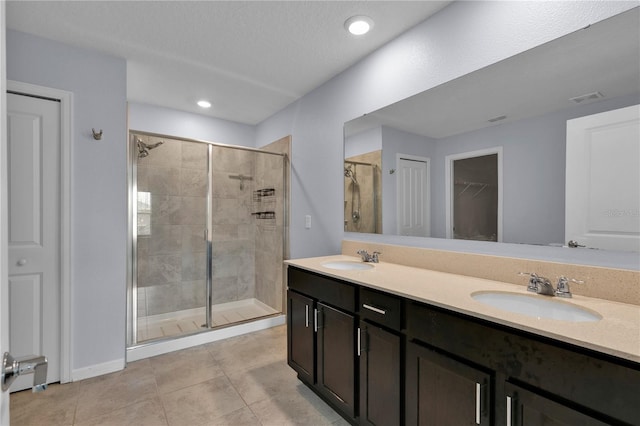 4492 Bluff Oak Loop, Kissimmee, FL 34746 - bathroom featuring a stall shower, double vanity, a spacious closet, tile patterned floors, and recessed lighting