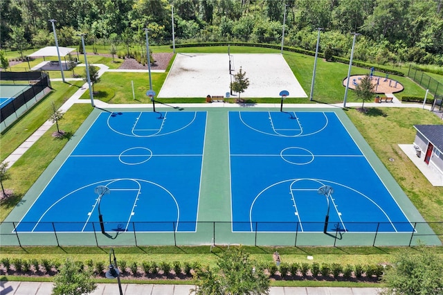 4492 Bluff Oak Loop, Kissimmee, FL 34746 - view of basketball court featuring community basketball court, a lawn, and a forest view